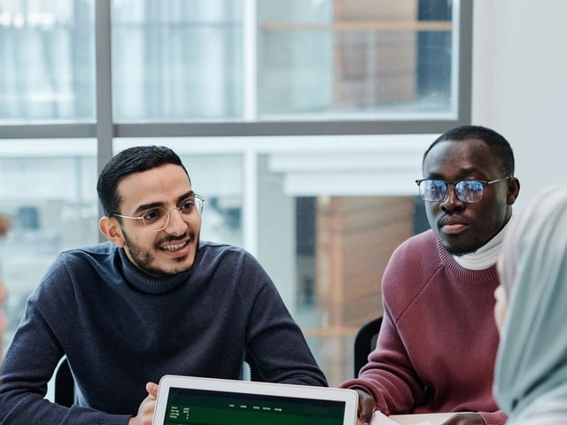 People in a work meeting before censoring, faces visible